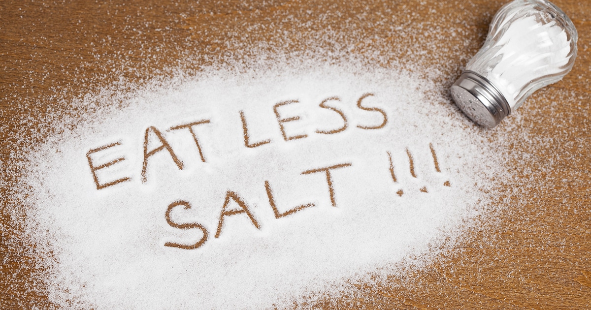 Eat less salt spelled out in a pile of salt