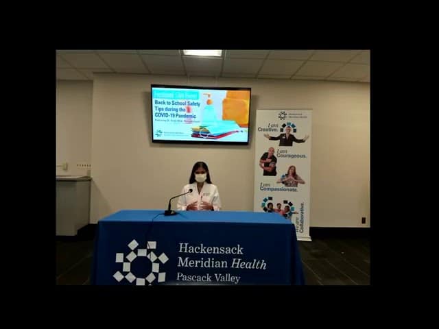 Doctor with mask on in lecture hall